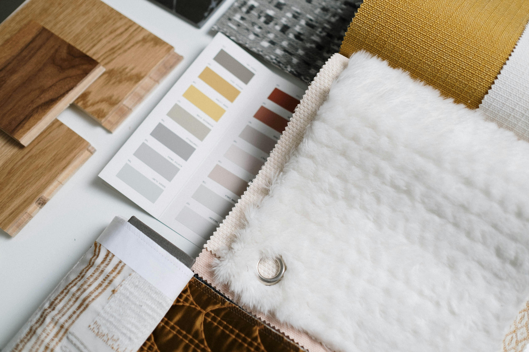 Color swatches and fabric samples on a white surface