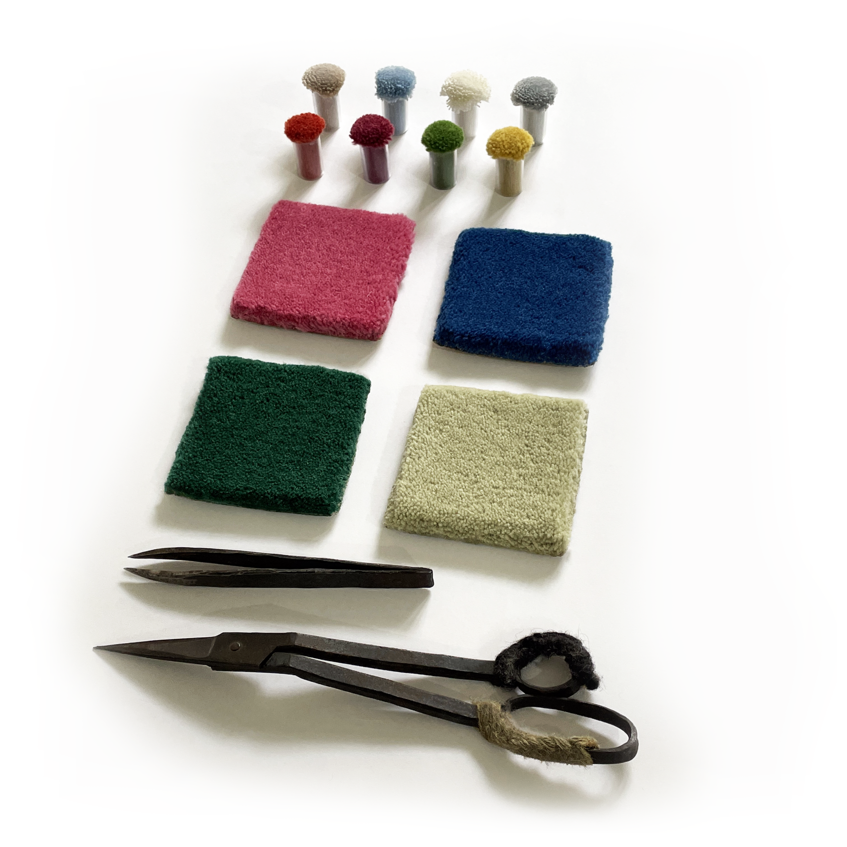 Colorful fabric samples and a pair of scissors on a white background